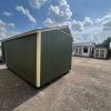 A 10x14 Garden Shed for sale in a parking lot.