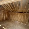 The inside of a 10x14 Garden Shed with wood framing available for sale in a nearby shed store.