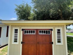 For sale: An 8x12 Studio Shed with a wooden door, available at our shed store near me.