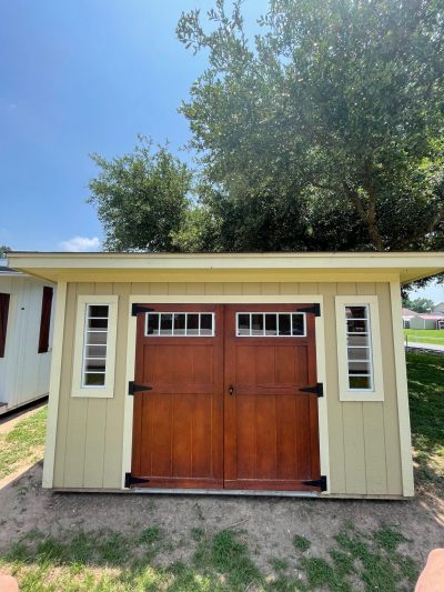 For sale: An 8x12 Studio Shed with a wooden door, available at our shed store near me.
