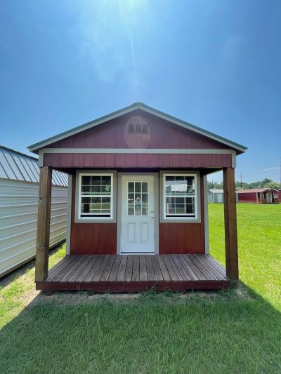For sale: A small 12x24 Cabinette Shed in the middle of a grassy field.