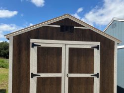 A 10x12 Utility Shed with two doors and a roof, available for sale.