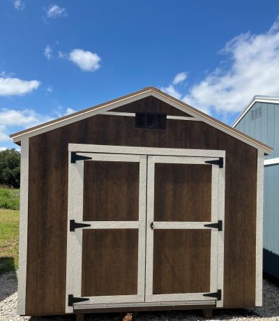 A 10x12 Utility Shed with two doors and a roof, available for sale.