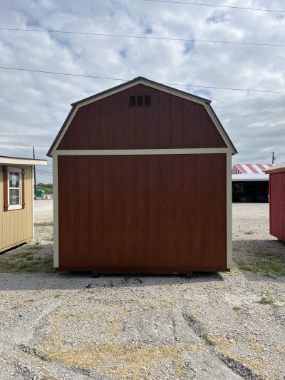 Two 10x12 Lofted Barn Sheds for sale in a parking lot.