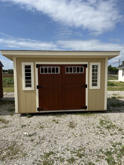 An 8x12 Studio Shed for sale with two doors and a roof.