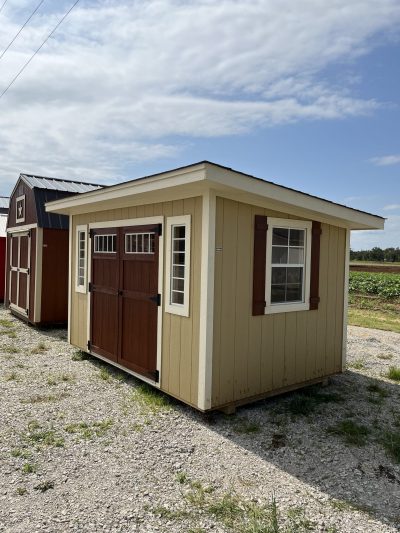 Two 8x12 Studio Sheds for sale next to each other in a field.