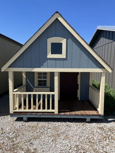A small dog house with a porch available at 8x12 Hideout Playhouse Shed on sale near me.