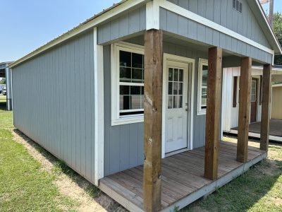 For sale 14x28 Cabinette Shed: A small gray 14x28 Cabinette Shed with a wooden porch is available for purchase.