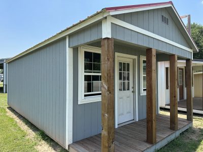 A 14x28 Cabinette Shed with a wooden porch is available for sale.