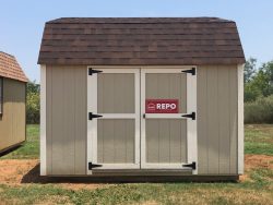 Two 10x16 Lofted Barns with a red sign on them, available for sale.