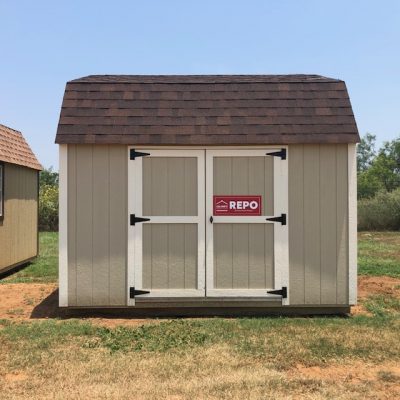 Two 10x16 Lofted Barns with a red sign on them, available for sale.