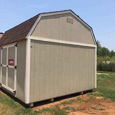 A 10x16 Lofted Barn for sale sitting on a grassy area.