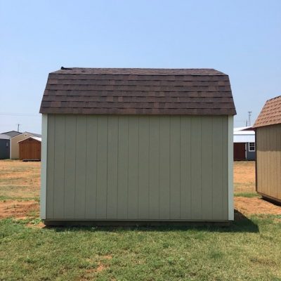 Two 10x16 Lofted Barns for sale in a field with a tan roof.