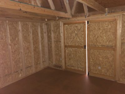 A 10x16 Lofted Barn with a door, available for sale.