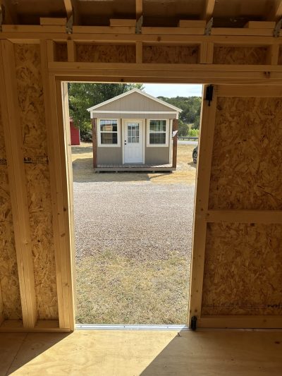Description: An 8x12 Garden Shed with an open door, conveniently located at a shed store near me.