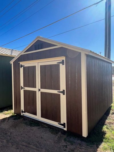 A 10x12 Utility Shed for sale sitting on a dirt lot.