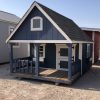 A small blue and white 8x12 Hideout Playhouse with a porch for sale.