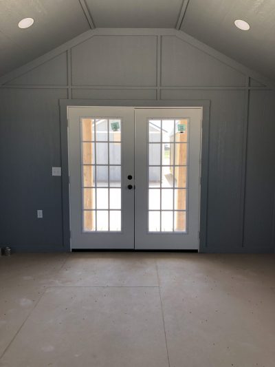 A vacant 14x20 Diamond Cabinette Shed with doors and windows available for sale.