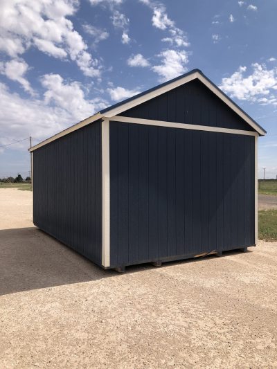 A 12x20 Chalet Shed for sale, colored in blue and white, sitting on a gravel lot.
