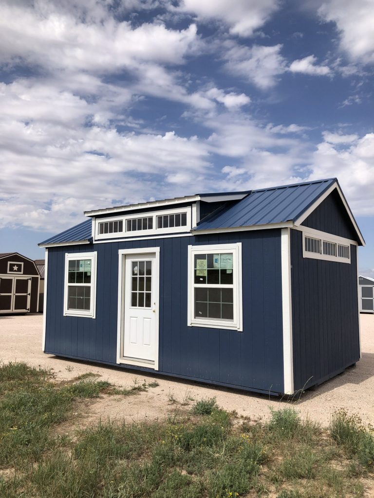  -  - A 12x20 Chalet Shed for sale, sitting in a field.