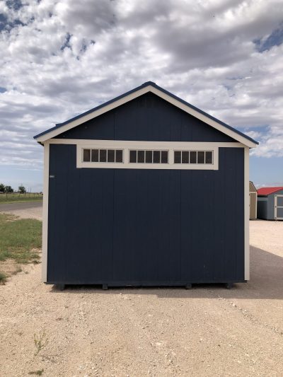 A 12x20 Chalet Shed for sale sitting on a gravel lot.