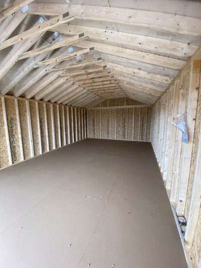 The inside of a 16x28 Garage Style Shed with wood beams available at the shed store near me.