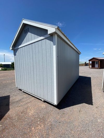 Two 10x16 Chalet Sheds on sale in a parking lot.