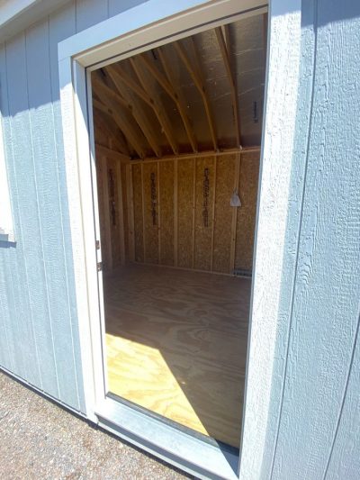 A 10x16 Chalet Shed on sale with an open door.