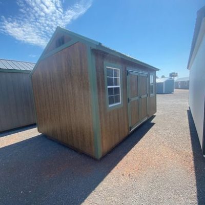 Two 10x16 Garden Sheds for sale in a parking lot.