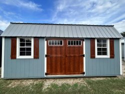 A 12x20 Lofted Barn with wooden shutters, available for sale near me.
