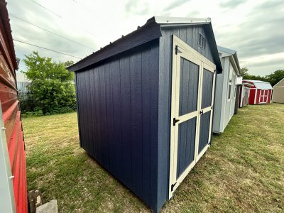 A blue and white 8x8 Basic Shed standing in a grassy area, available at a shed store near me.