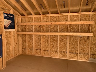 A storage room with shelves and 10x14 Garden Sheds available for sale near me.