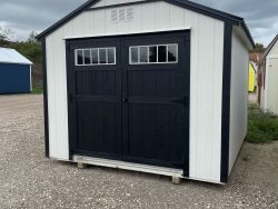 A white and black 10x12 Utility Shed with a black door available for sheds sale near me or sheds on sale.