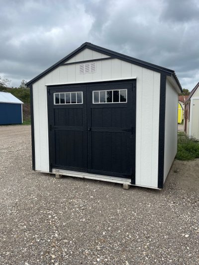 A white and black 10x12 Utility Shed with a black door available for sheds sale near me or sheds on sale.