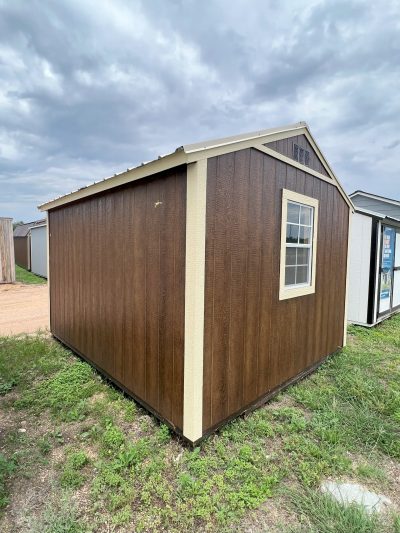 A 10x12 Utility Shed for sale in a grassy area.