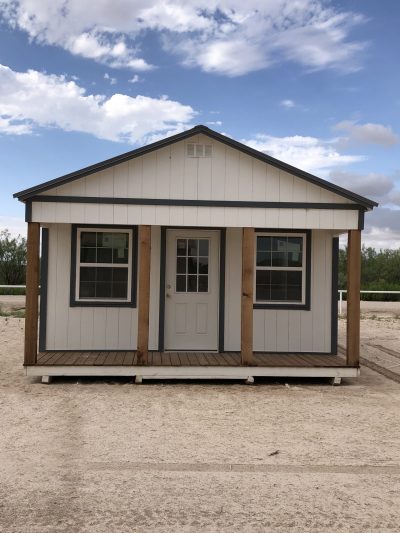 A 16x30 Cabinette Shed for sale sitting on a dirt lot near a shed store and sheds sale nearby.