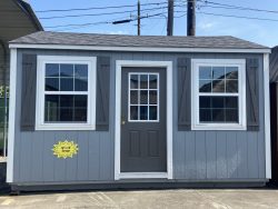  - A 12x16 Garage Shed with white shutters and a door for sale.