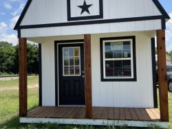 A small black and white 12x24 Lofted Barn with a star on it available for sale.