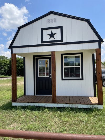 A small black and white 12x24 Lofted Barn with a star on it available for sale.