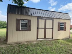 A 12x24 Lofted Barn shed for sale in the yard.
