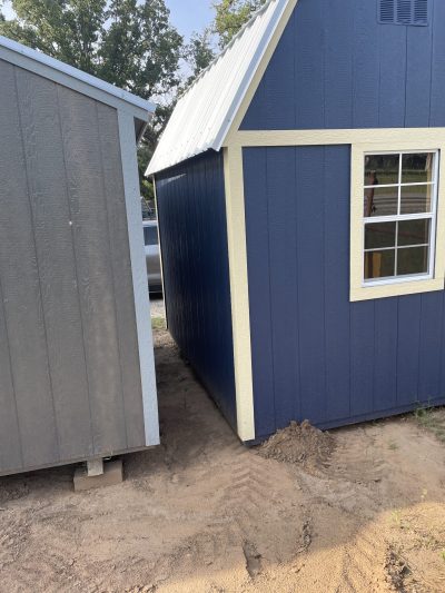 A blue 8x10 Lofted Barn with a yellow roof, available for sale sheds on sale.