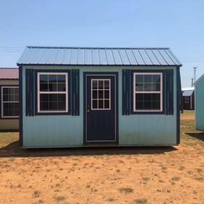Two 10x16 Garden Sheds for sale in a field.