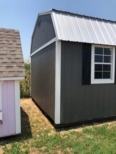 Two 12x24 Lofted Barn sheds on sale near me, located next to each other.
