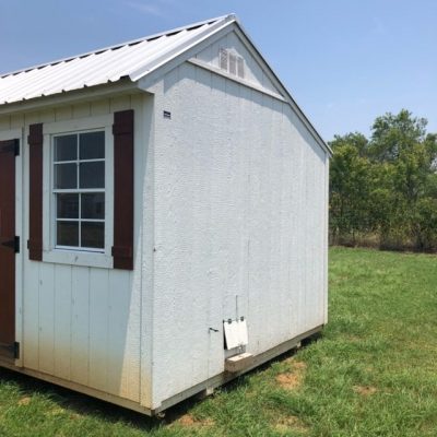 A 10x16 Garden Shed for sale sitting in a field.