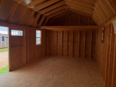 The interior of a 12x24 Lofted Barn, featuring a door.