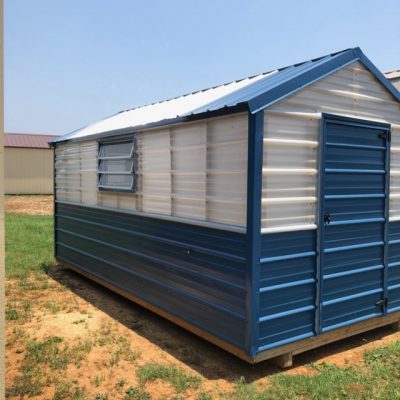 A 8x16 Greenhouse Shed shed for sale, sitting in a field.