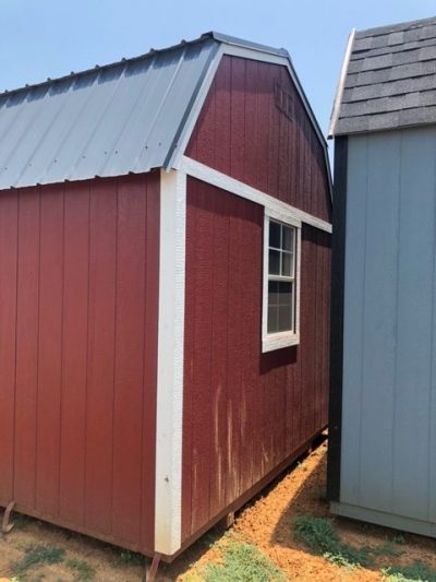 Two 10x16 Lofted Barn sheds for sale next to each other in a field.