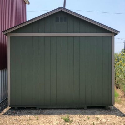 A 12x20 Cabinette Shed for sale sitting on a gravel lot.