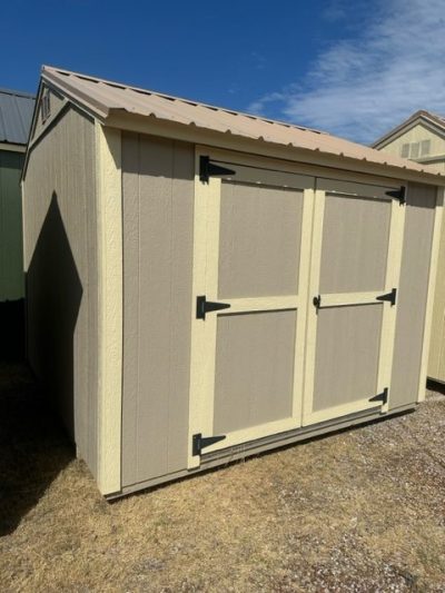 A 10x10 Utility Shed for sale with two doors and a roof.
