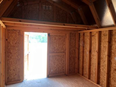 Find 10x16 Lofted Barns on sale near me at a shed store with wood walls and a door.